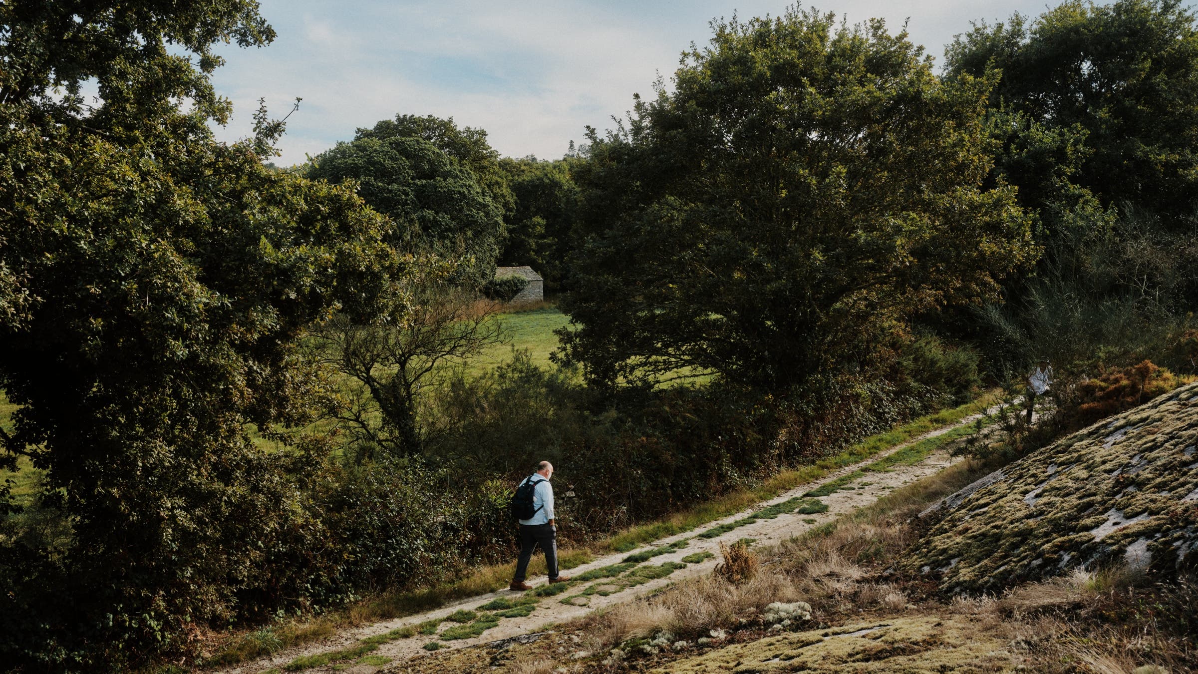 José walks up a gentle sloping path in the Spanish countryside.