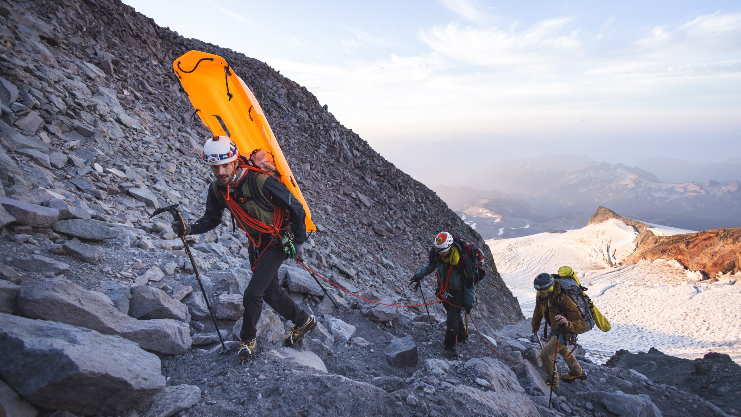 Mountaineers walking up a steep incline.