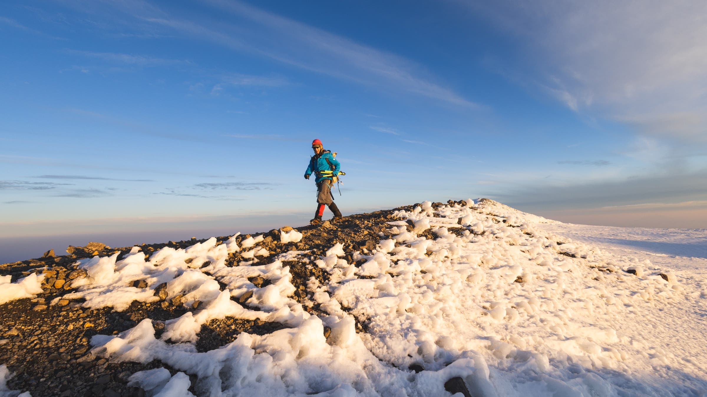 Eric walking down a gently sloping summit.