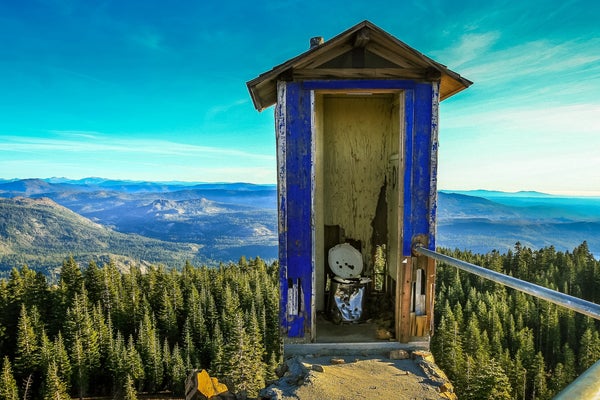 an outhouse with a mountain view