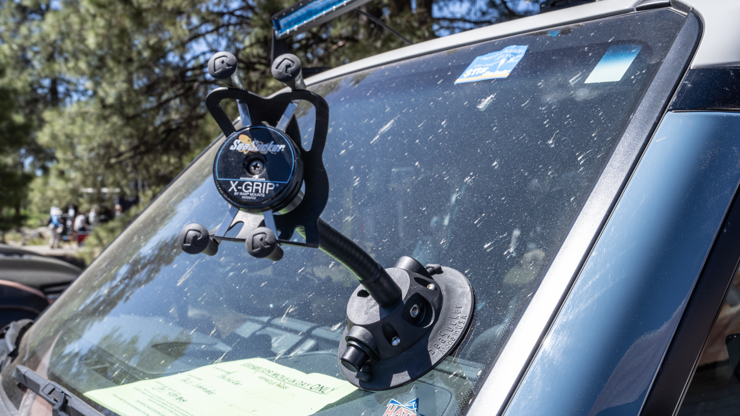 suction cup phone mount on the windshield of a car outside at Overland Expo West