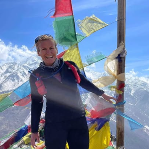 shelley johannesen in front of prayer flags at everest base camp in a photo shared to social media in 2022