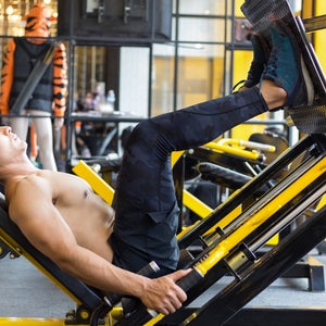 man doing leg press at gym