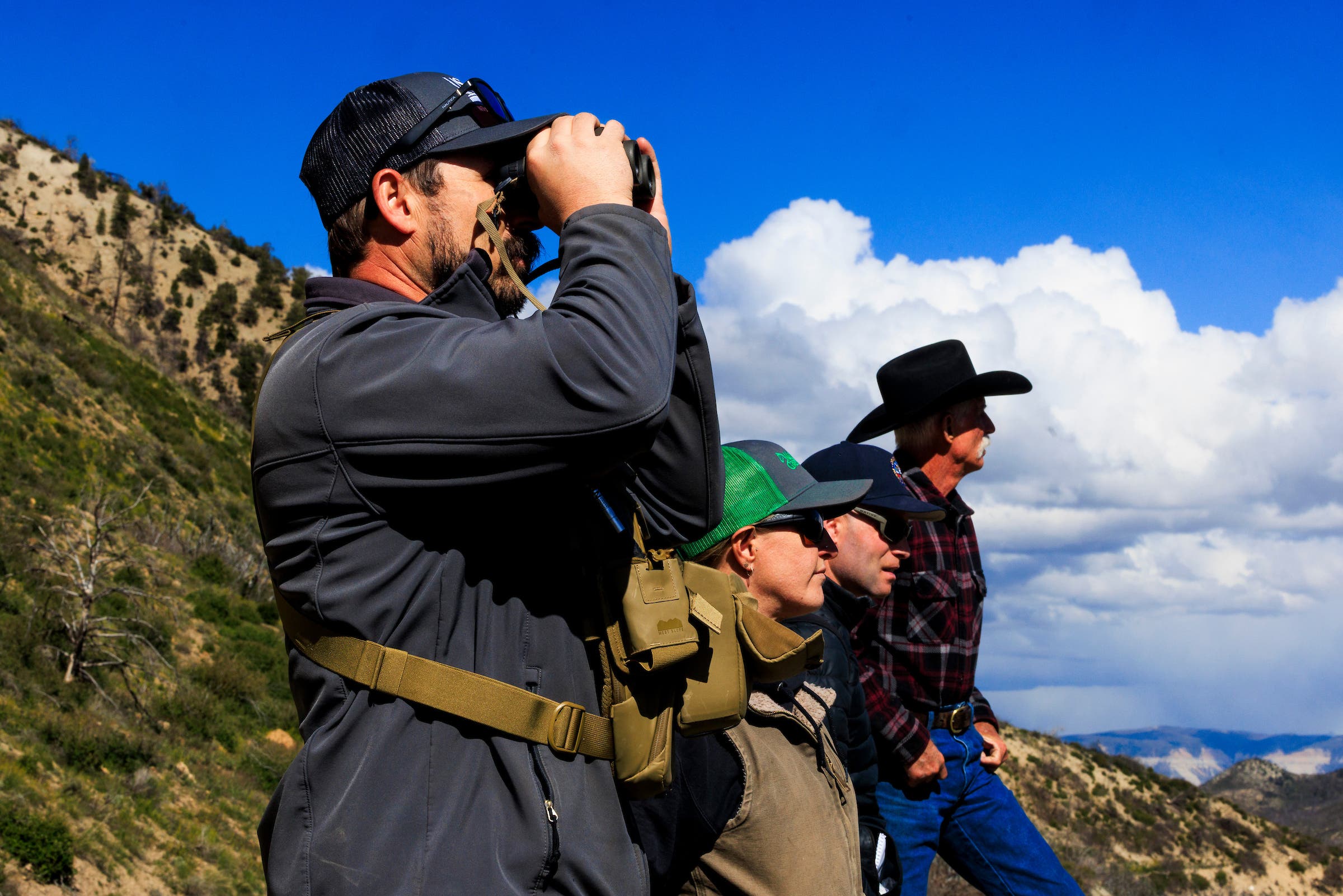 Members of the Colorado Range Rider program and tracking instructors look out across the landscape.