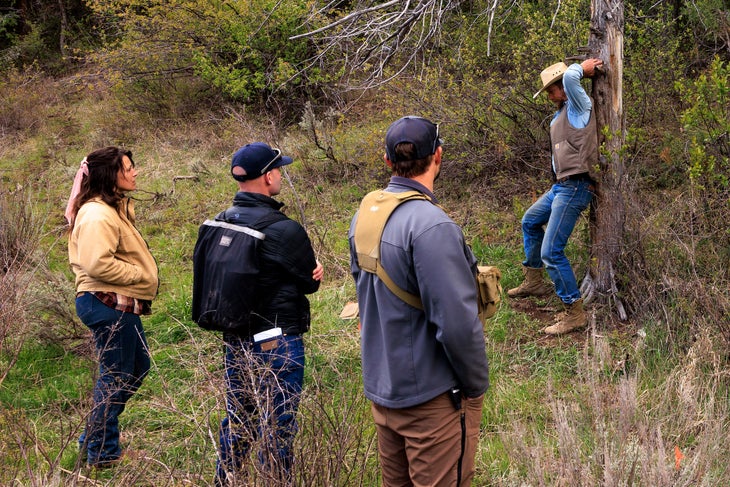 CyberTracker evaluator Phil Johnston shows students how a bear used a tree as a scratching post.