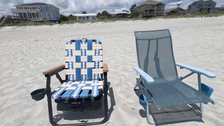 Two beach chairs—one mesh, one lawn chair style—on white sandy beach