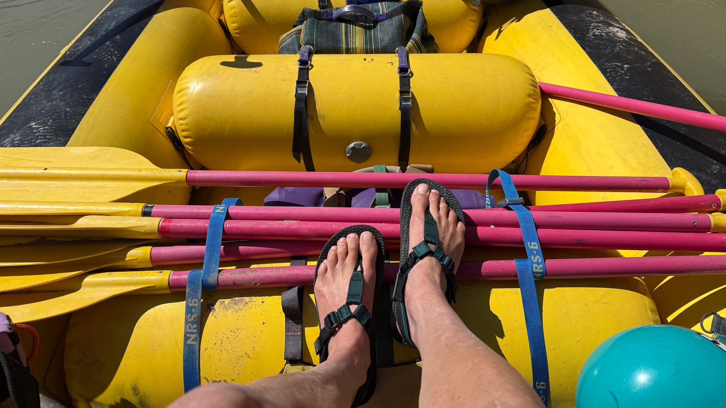Tester in rafting boat wearing Bedrock Cairn Evo 3D PRO Sandals water shoes