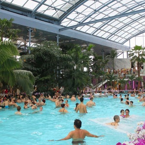 Guests relax in a heated pool in Therme Bucharest