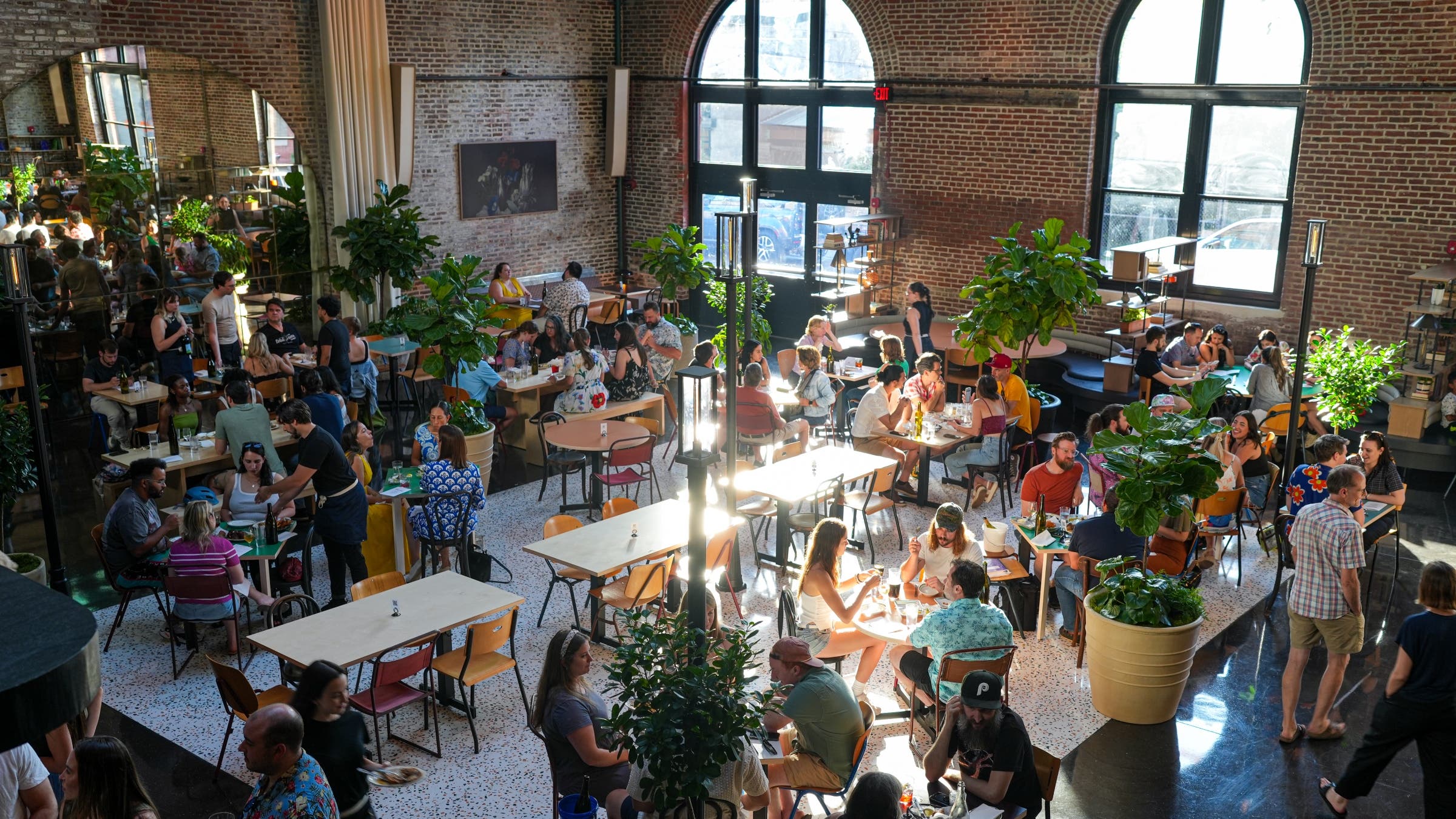 Above shot of an open room with arched windows and brick walls.