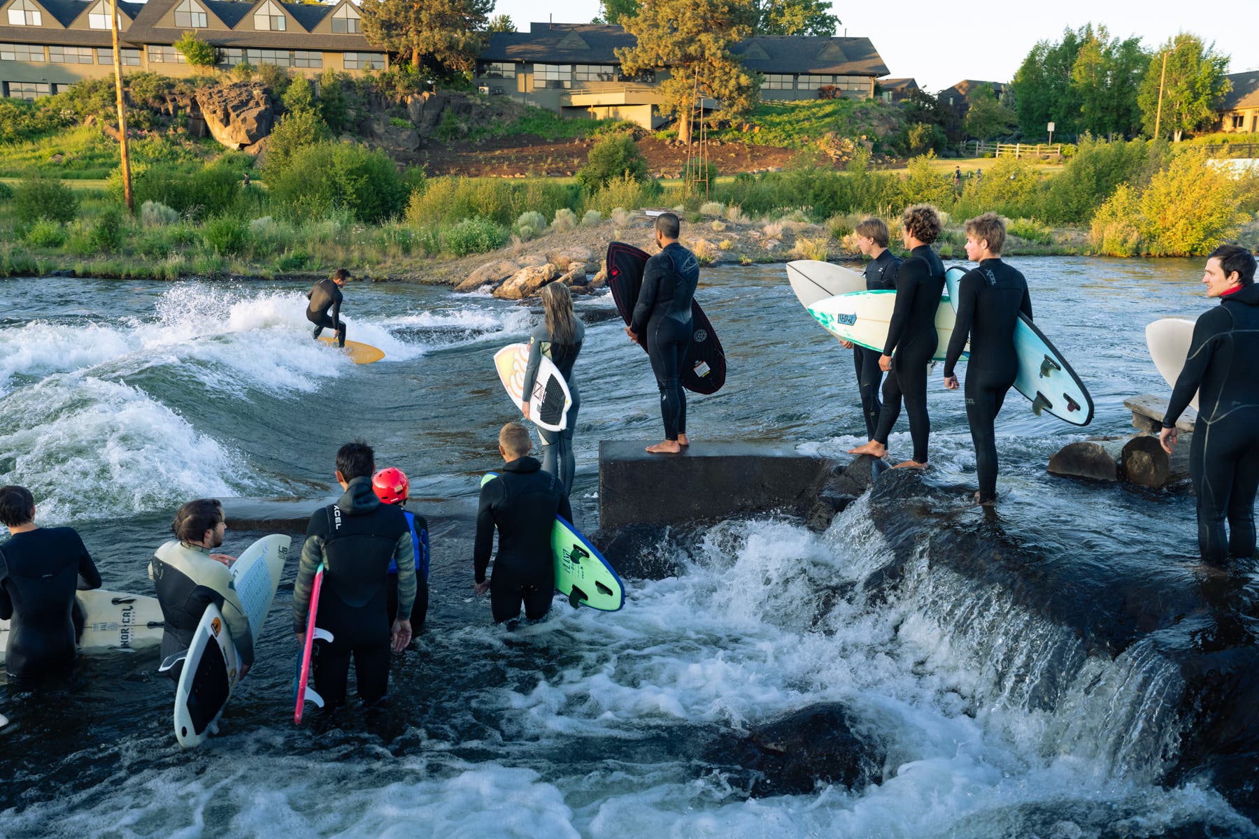 River surfing on the Deschutes River takes place at the Bend Whitewater Park in Bend, Oregon.