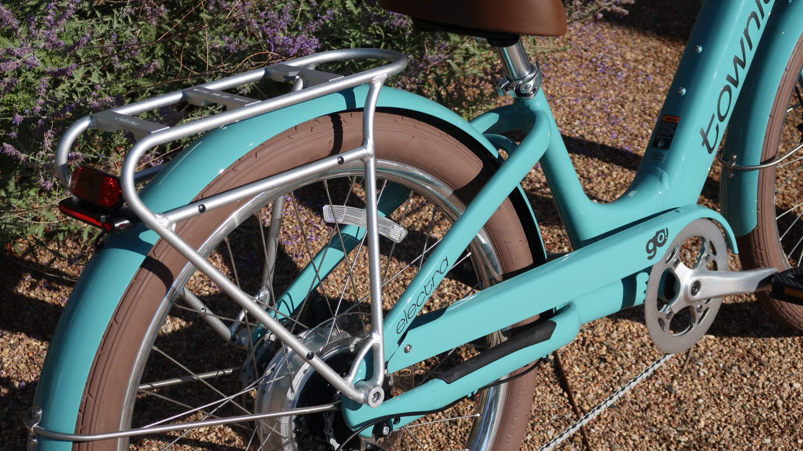 Rear rack and fender detail on the Electra Townie Go! electric cruiser bike in seafoam blue