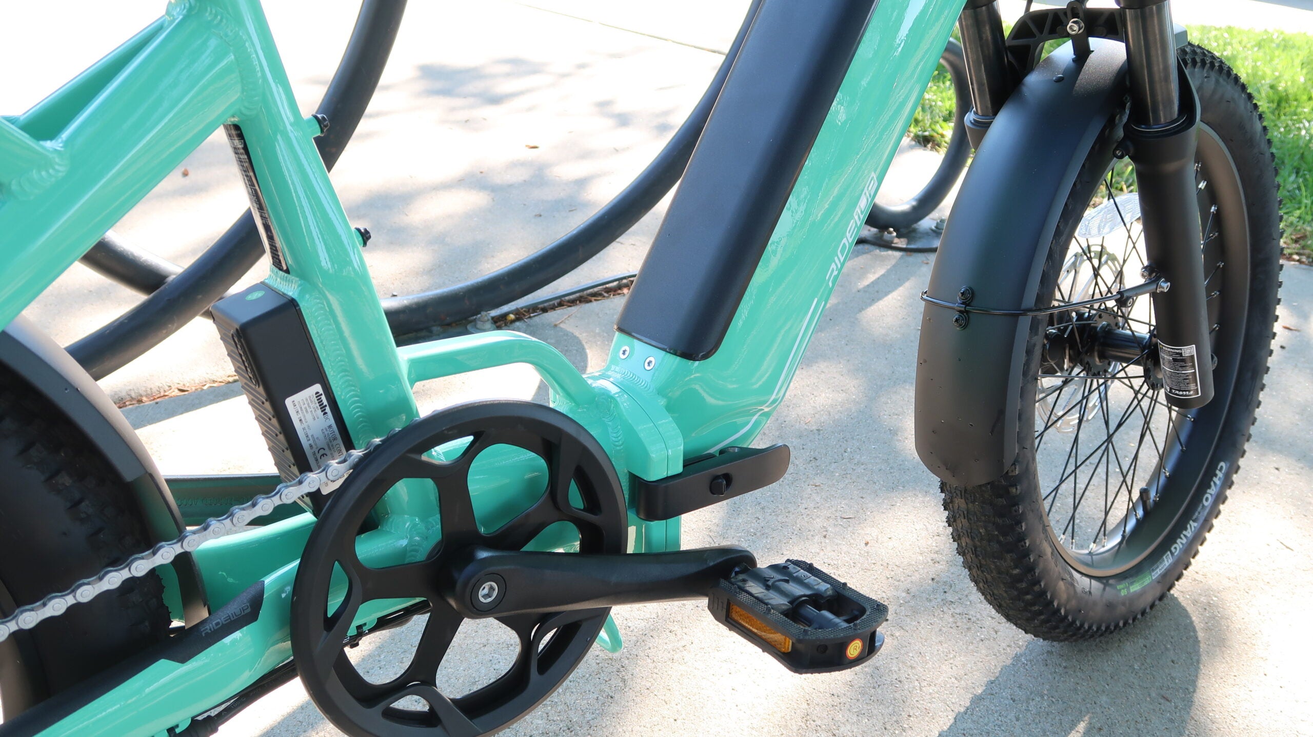 Close-up of the Ride1Up Portola's mid-drive motor, crankset, and fat tires