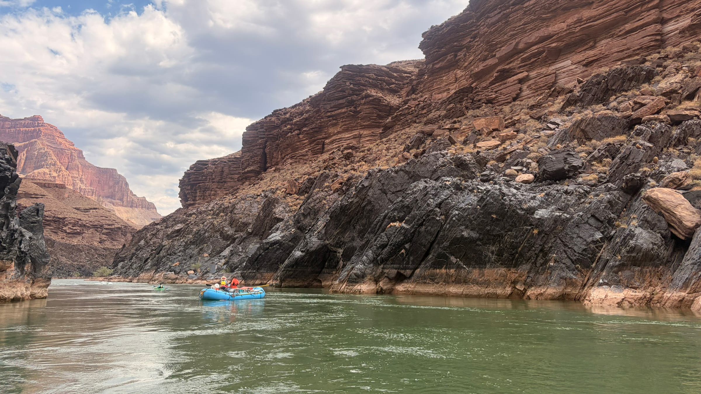 A single raft floating down the Grand Canyon on a rafting trip