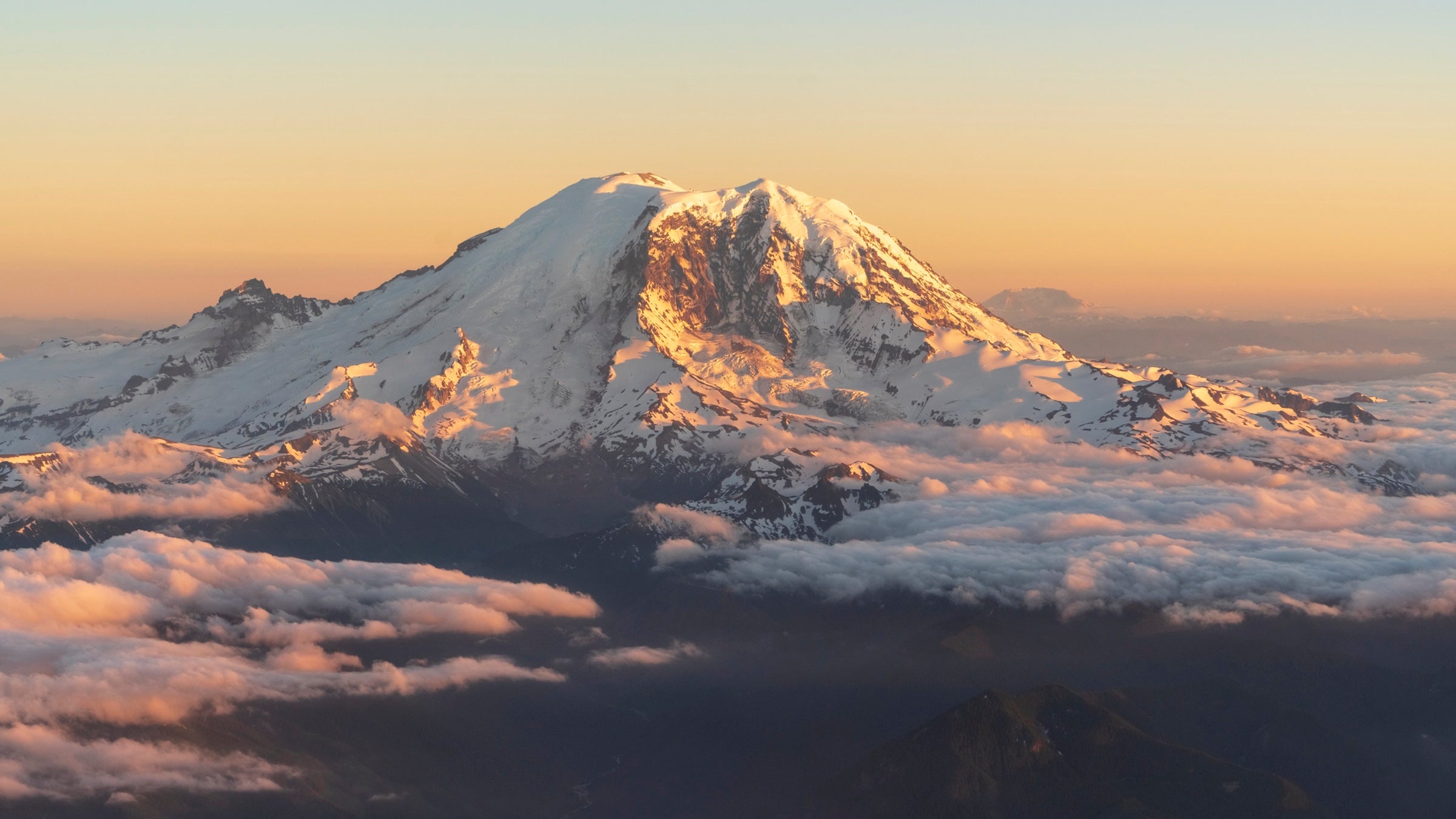 Views of mount rainier from an airplane window at sunset