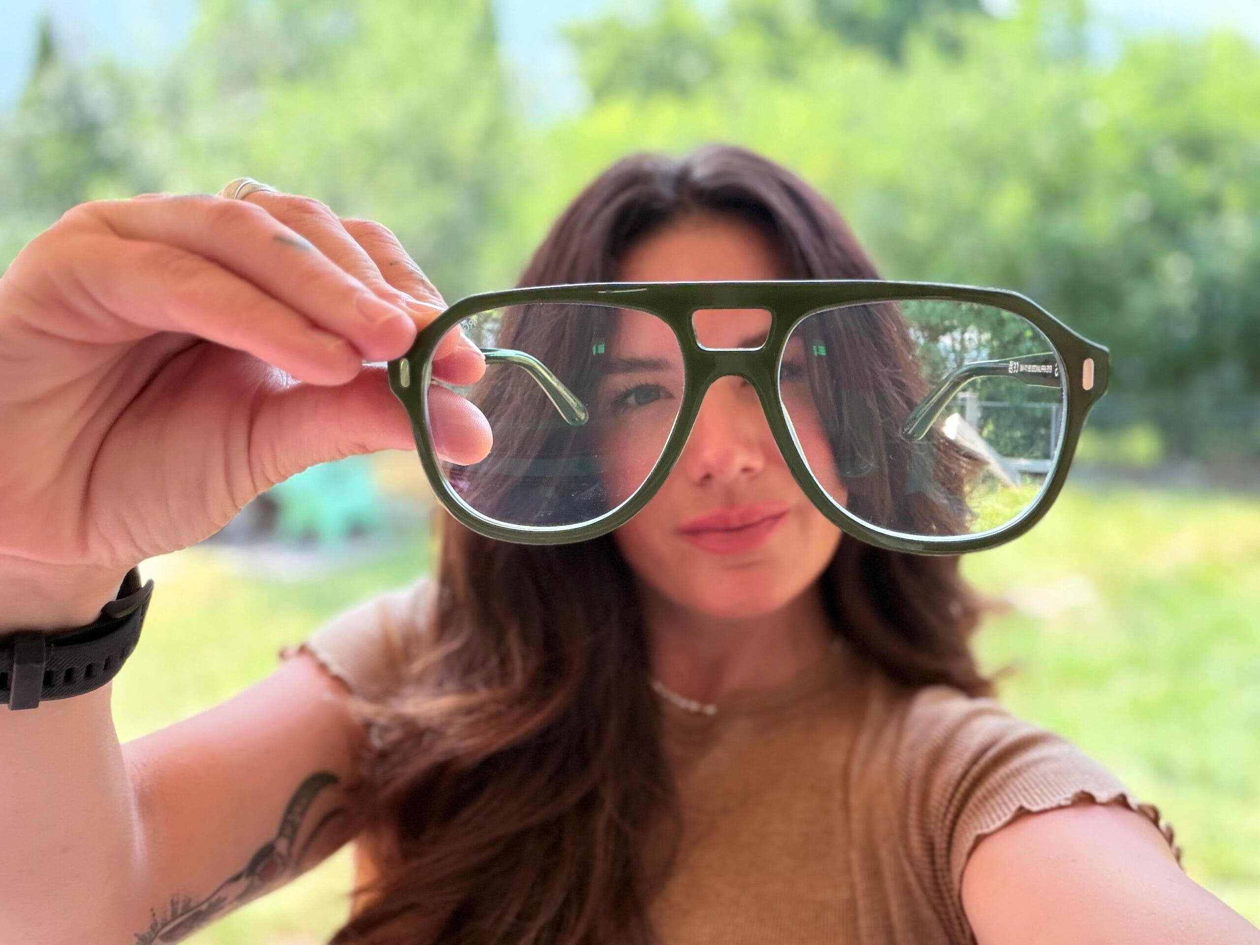 outside associate editor madison dapcevich holds the jeremy jones x caddis glasses