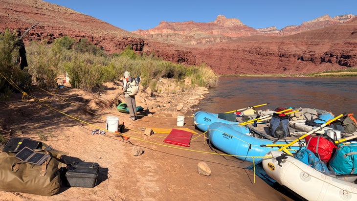 A group of boats tied up on the riverbank of the Grand Canyon rafting trip
