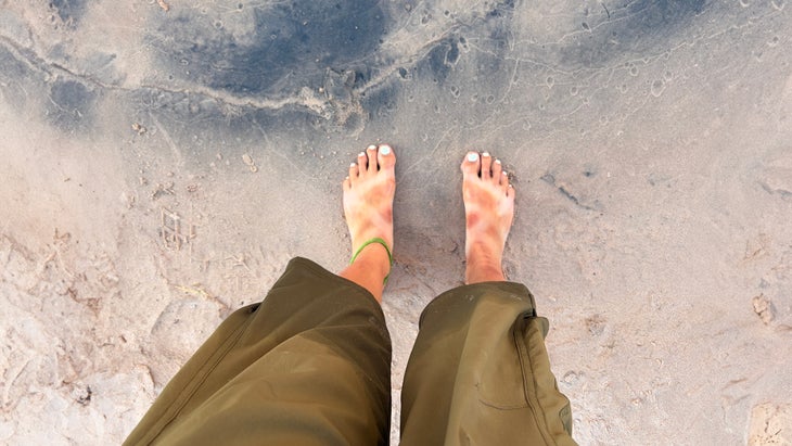 Chaco tan lines on the banks of the river while on a rafting trip