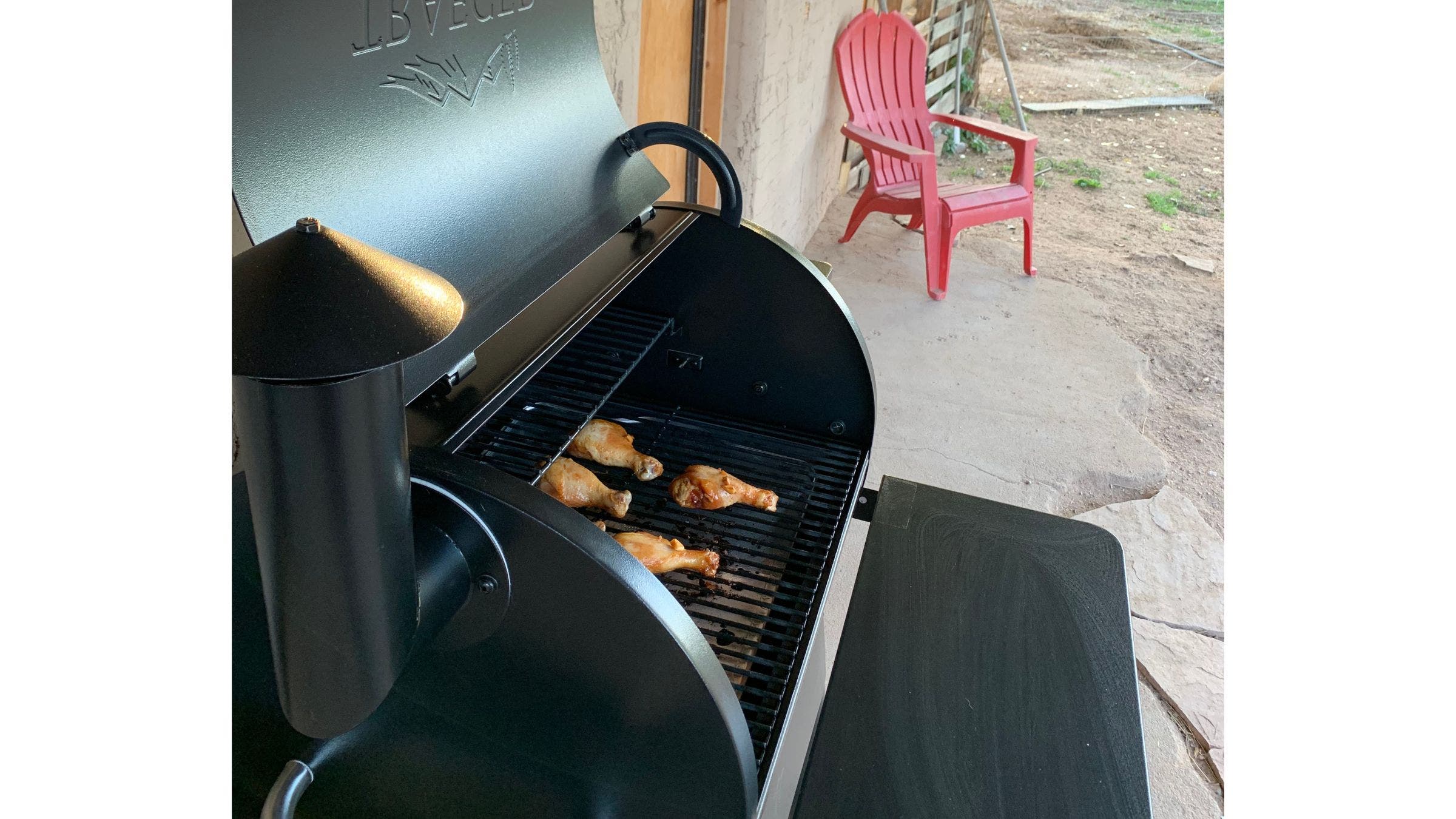 traeger on porch cooking drumsticks
