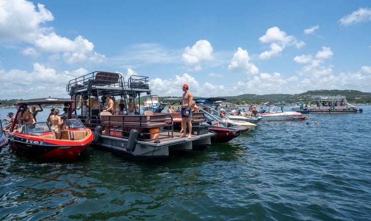 barges and boats tied together on a lake for boatsetter rodeo