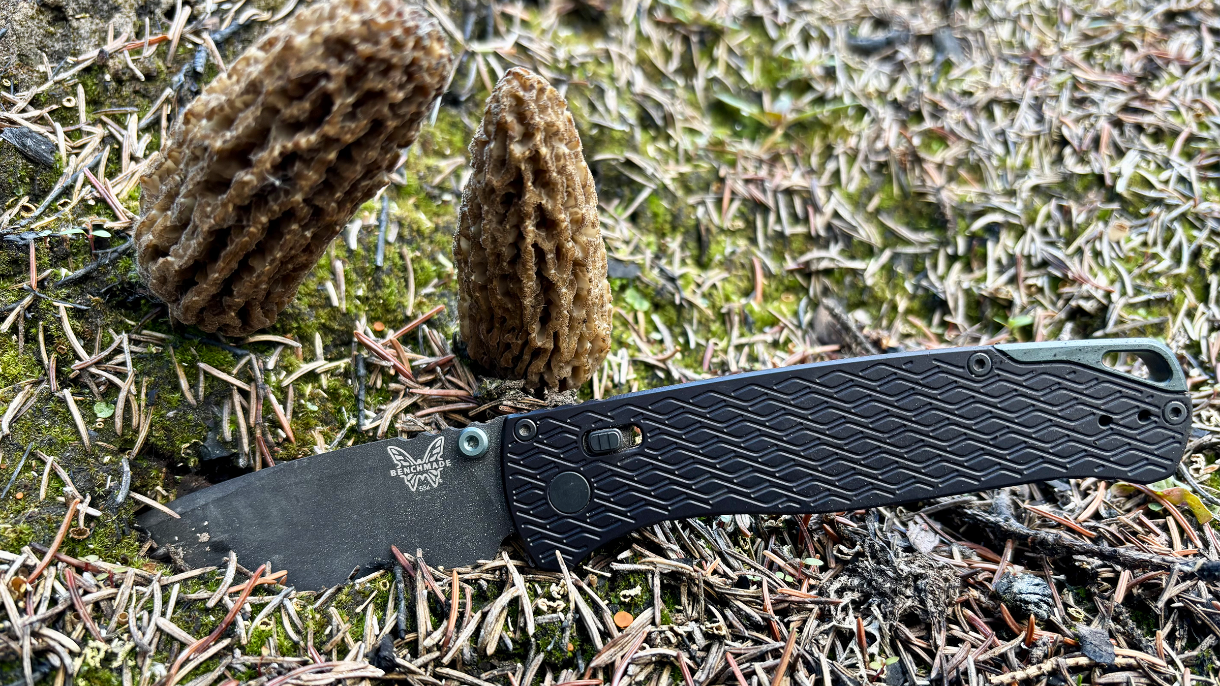 Benchmade Bugout Vapyr knife in front of morels