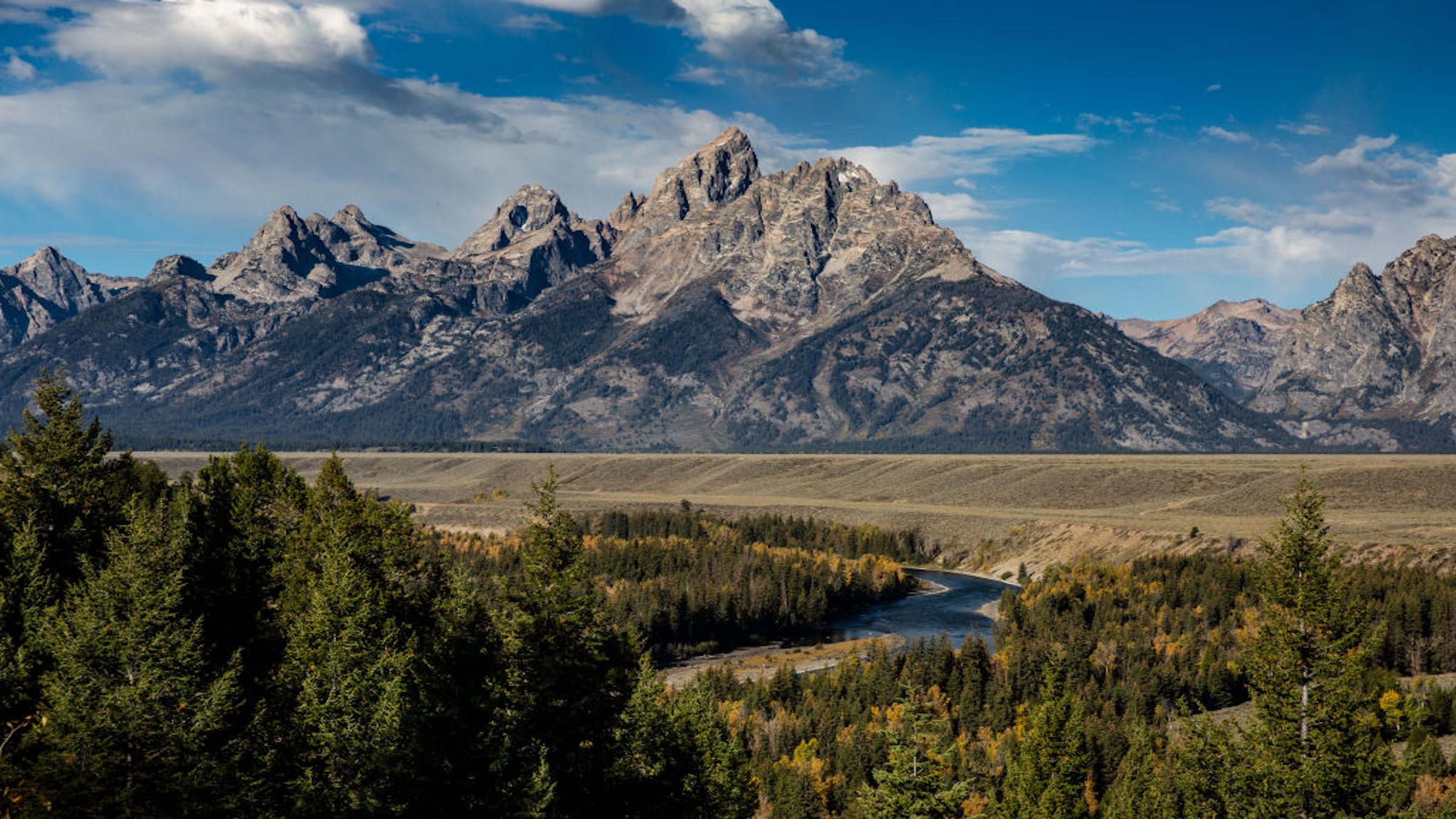 JACKSON LAKE, WY - OCTOBER 1: The dramatic Grand Teton Mountain Range is viewed from the Snake River Overlook (made famous by photographer Ansel Adams) on October 1, 2022, at Jackson Lake, Wyoming. Grand Teton National Park is an American National Park in northwestern Wyoming and just south of Yellowstone National Park. At approximately 310,000 acres, the park includes the major peaks of the 40-mile-long Teton Range as well as most of the northern sections of the valley known as Jackson Hole. (Photo by George Rose/Getty Images)