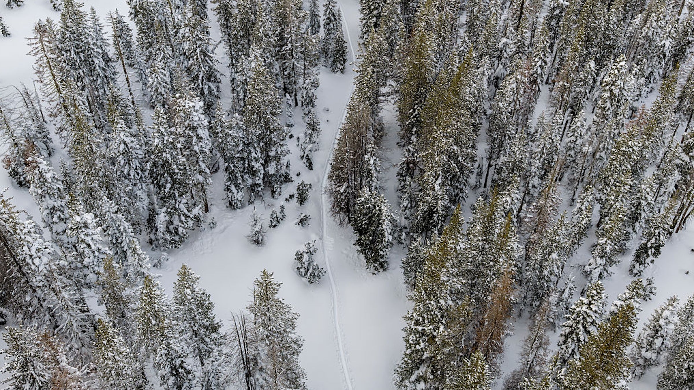 A aerial view of a snow-covered road is seen by the Castle Peak Trailhead near Soda Springs, Calif on February 20, 2026