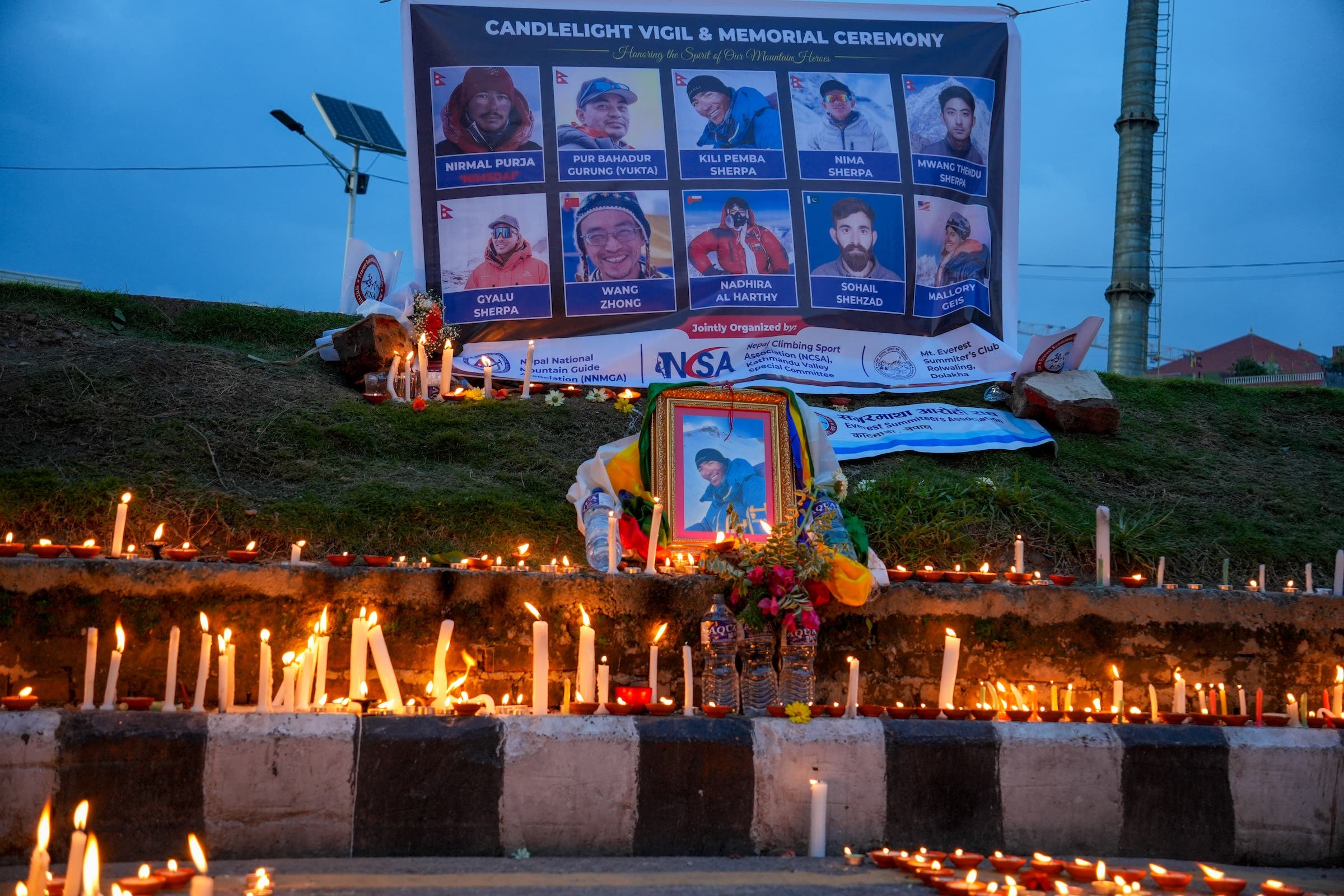 Mourners light candles during a candlelight vigil to commemorate climbers who died in a recent avalanche on Broad Peak