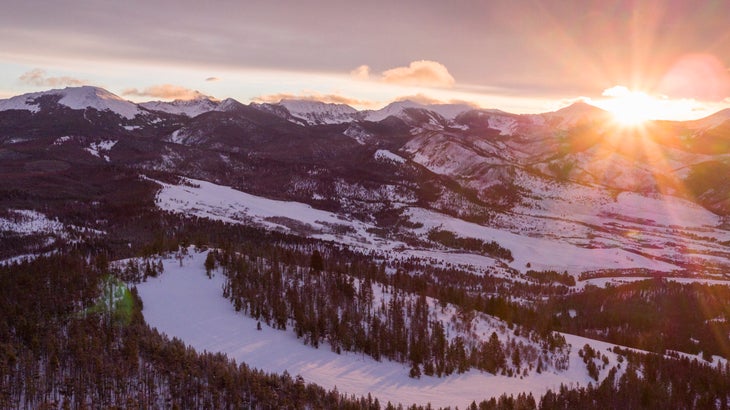 Sunrise over Maverick Mountain ski runs covered in snow, pioneer mountains in the background