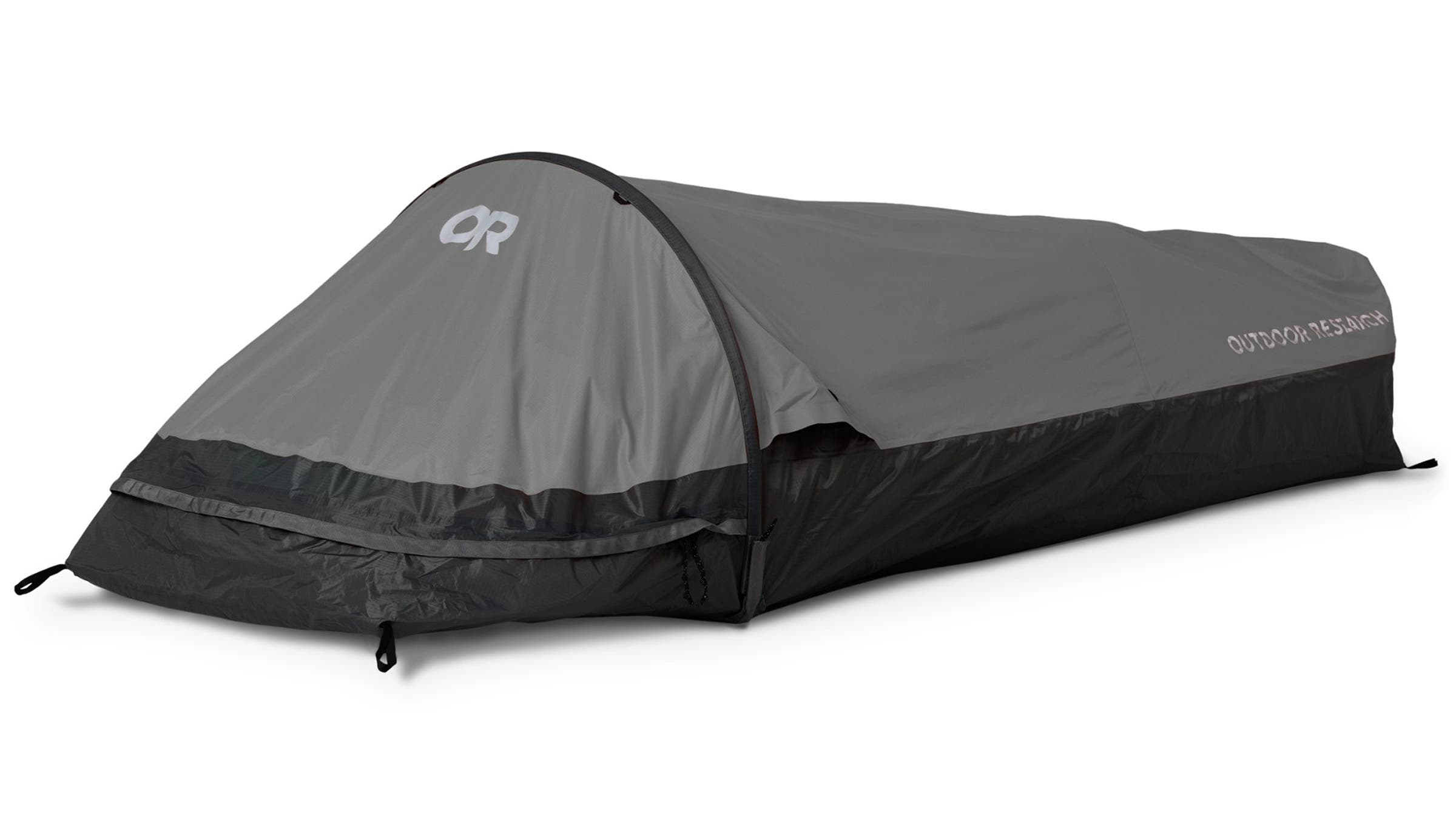 Gray and black Outdoor Research Helium Bivy sleeping shelter set up against a plain background. Offers compact, weatherproof protection for minimalist fastpacking trips.