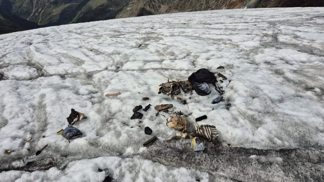 the backpack and its contents scattered over a snowy field