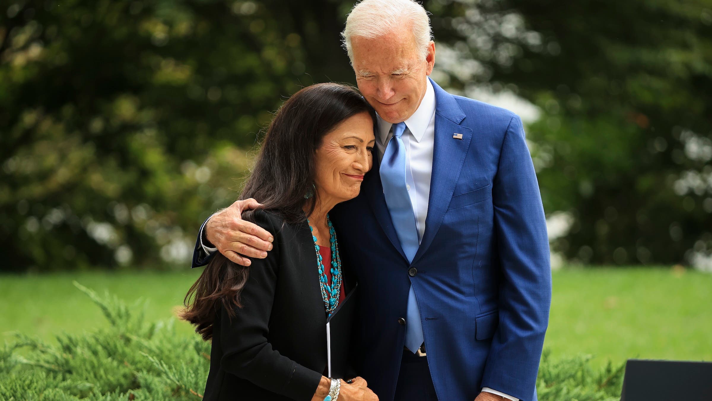In October 2021, President Joe Biden embraces Secretary of the Interior Deb Haaland before announcing the expansion of areas of three national monuments