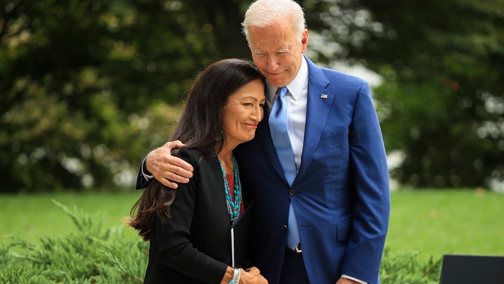In October 2021, President Joe Biden embraces Secretary of the Interior Deb Haaland before announcing the expansion of areas of three national monuments
