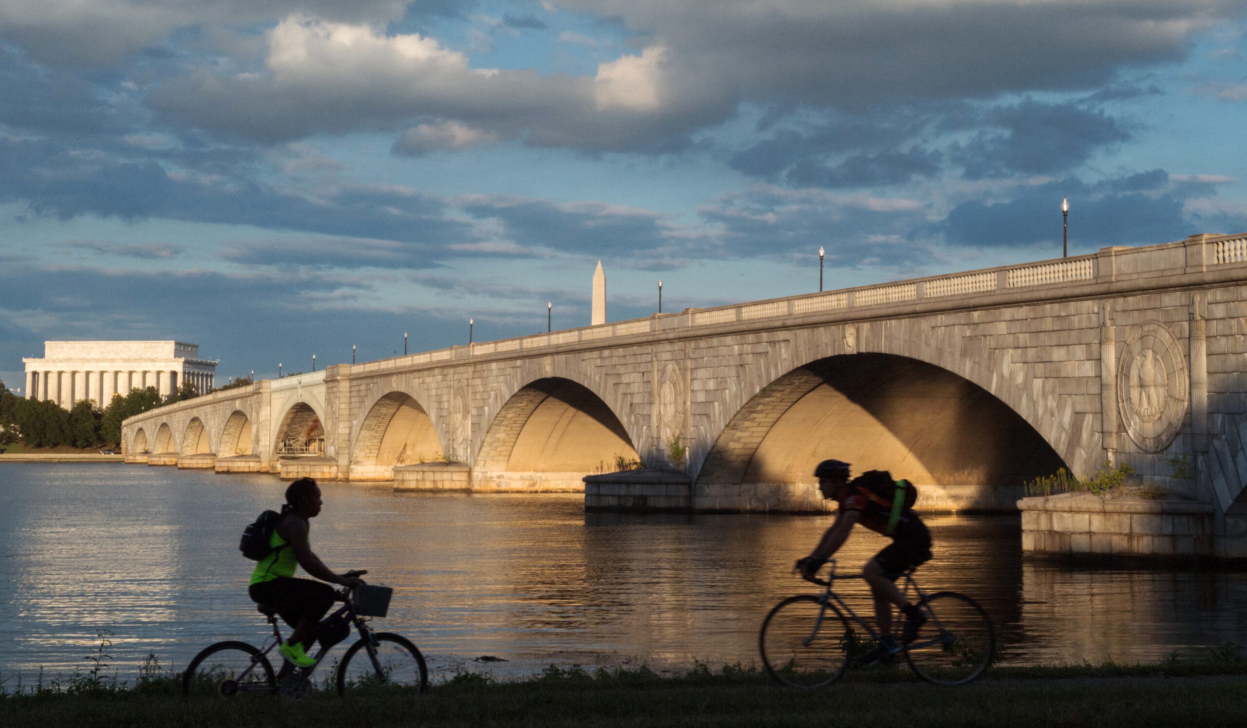 Bicyclists ride along the Mt. Vernon Trail that follows the Potomac River in Virginia near the Arlington Memorial Bridge, the Lincoln Memorial and the Washington Monument.