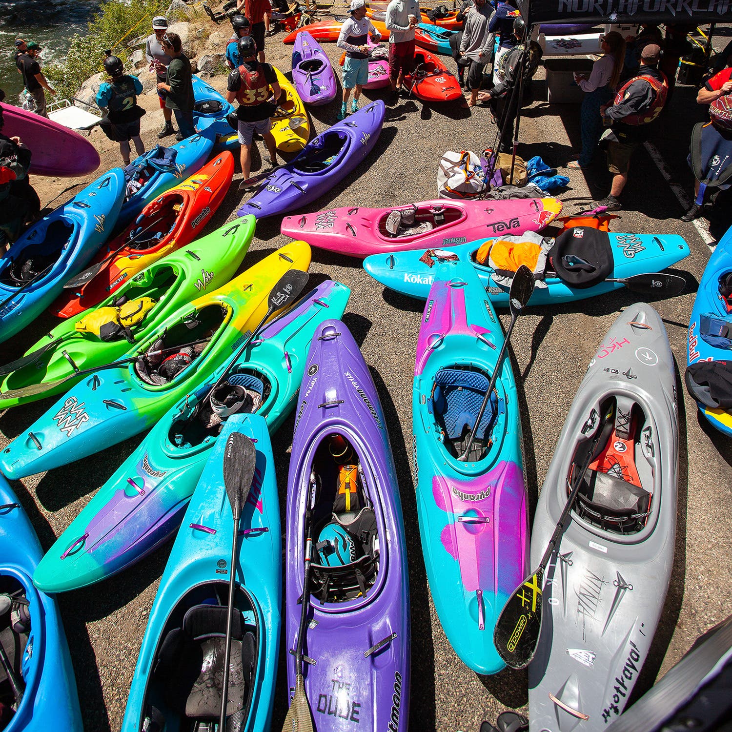 dozens of colorful kayakers shown on the roadside of the north fork championship race