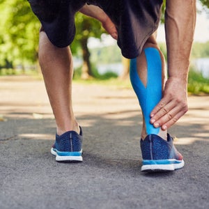 person massaging their calves