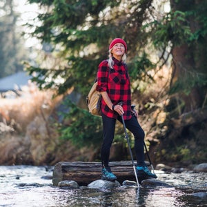 A senior woman walking in woods