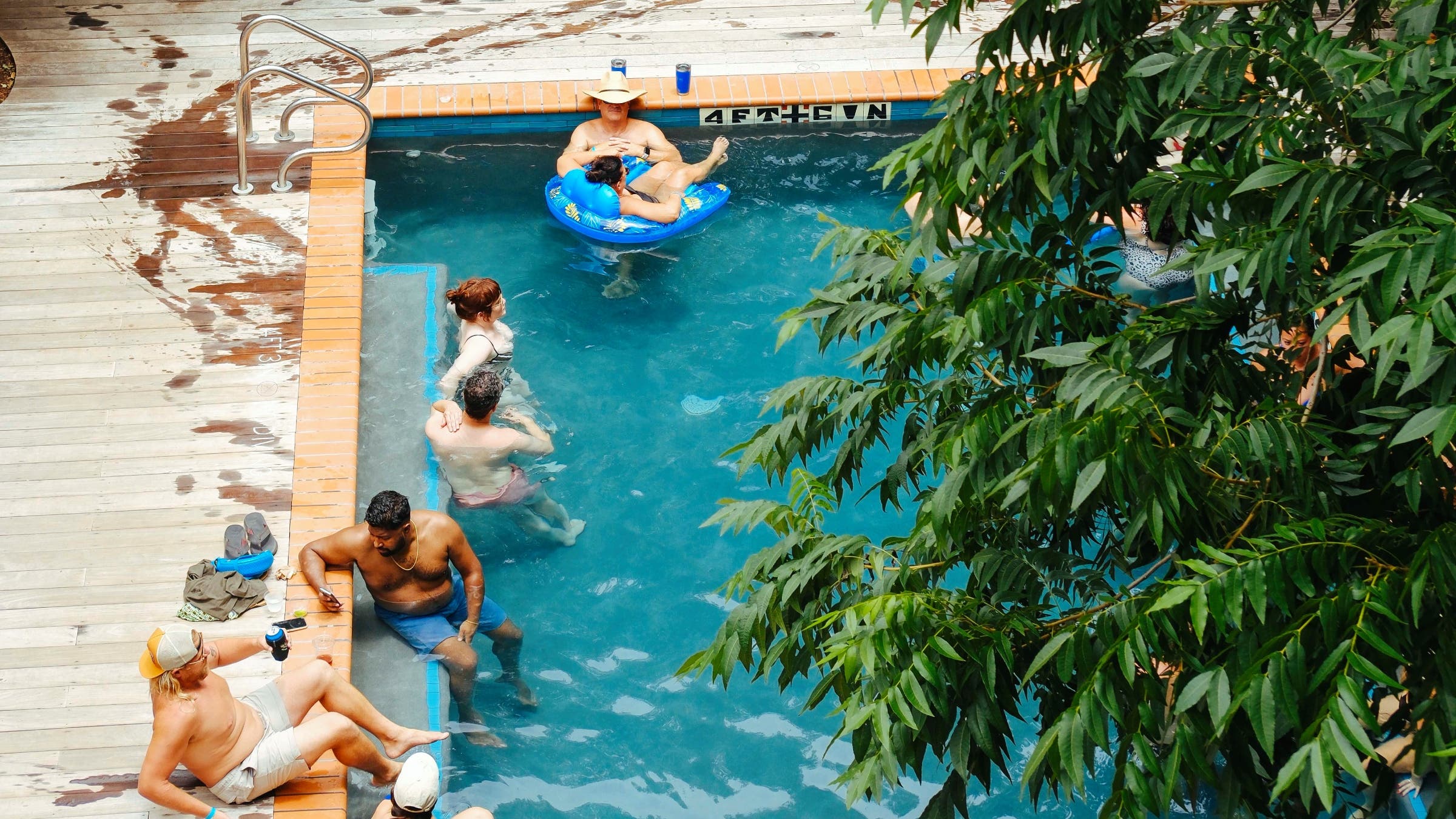 Guests lounge in a hotel pool.