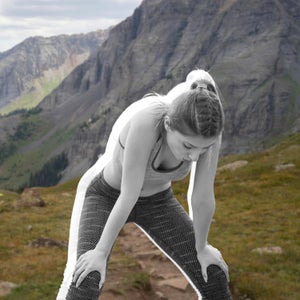 woman tired on trail after workout