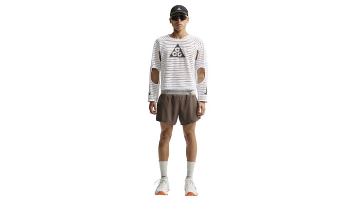 Man wearing a white shirt with many holes in it.