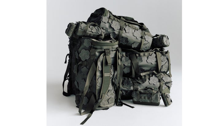 Dark-toned duffel bags with floral appliques.