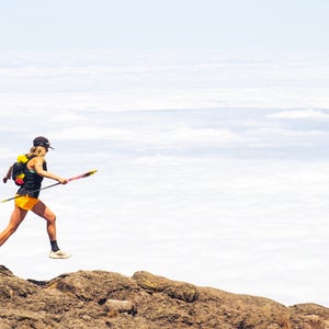 erin ton running atop mount kilimanjaro ith a cloudy white background