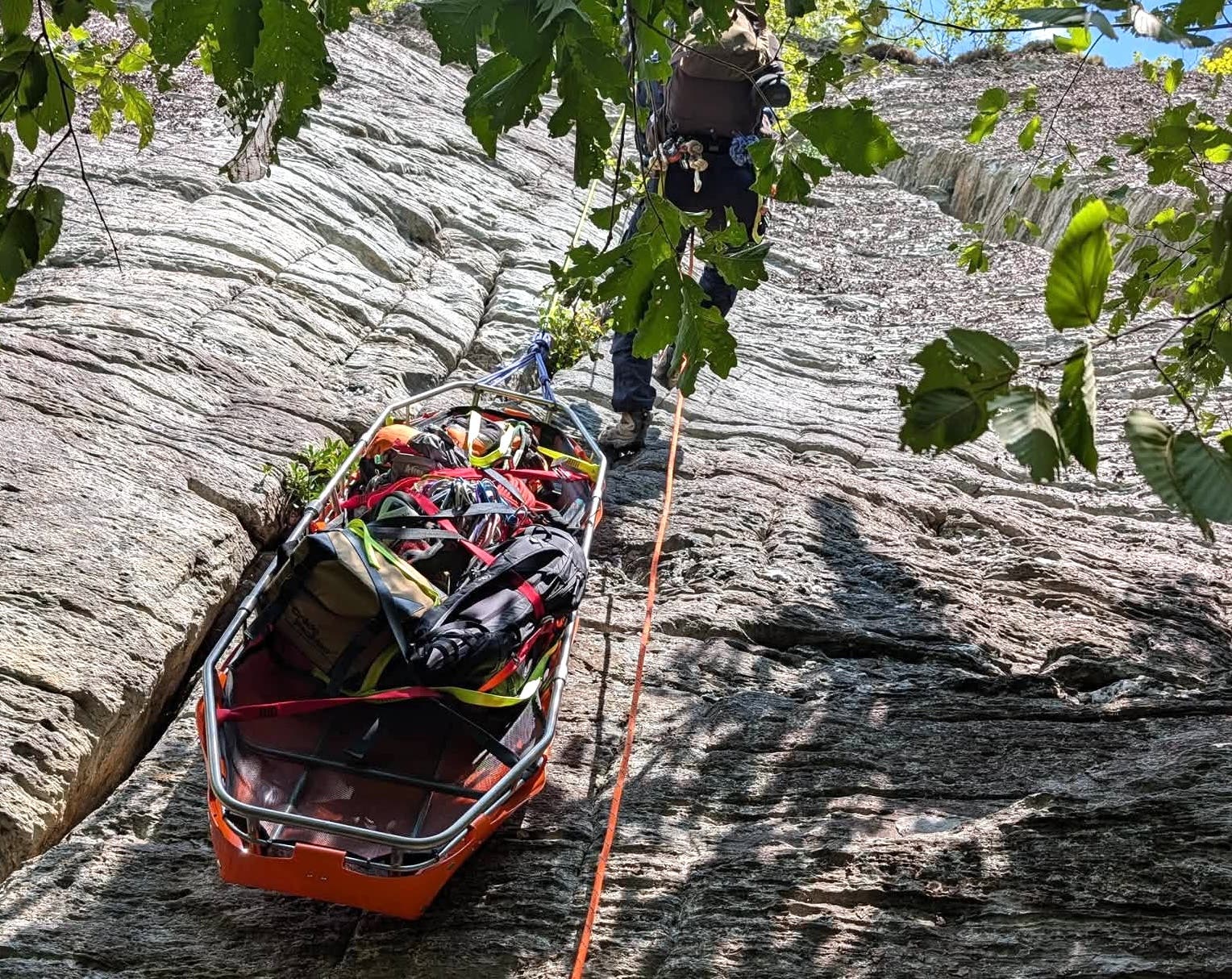 The complex rescue involved 24 agencies and required rescuers to haul a transport litter up a steep rock face to reach the injured climber