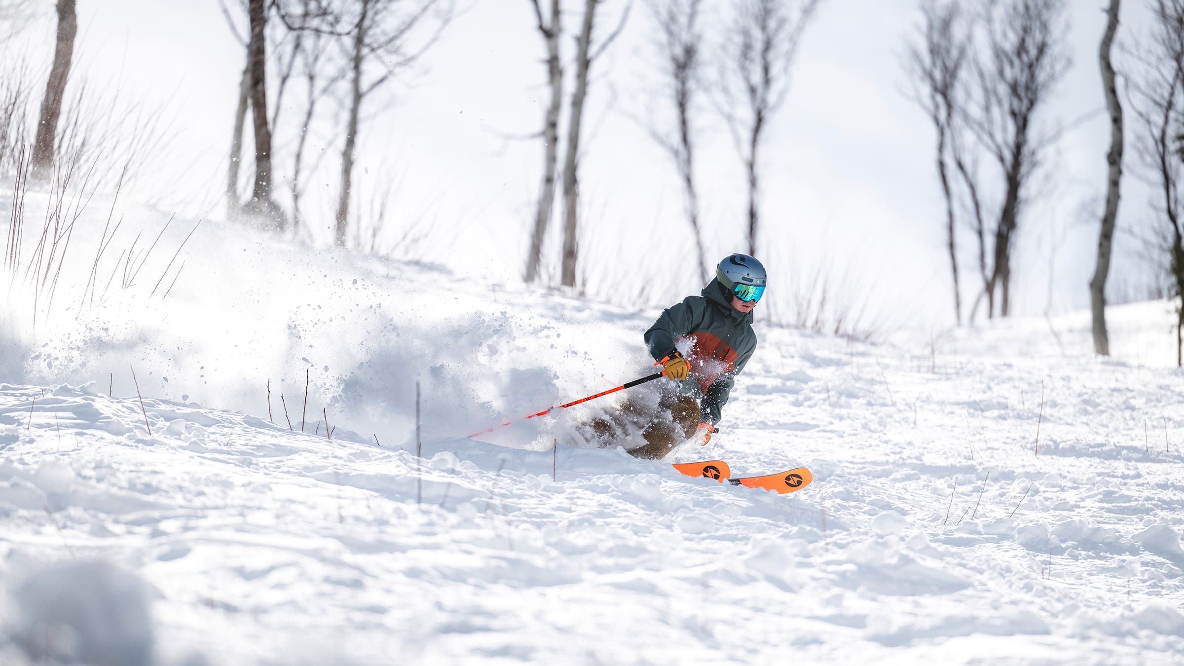 Skier on Blizzard Rustler all-mountain ski, skiing through crud off-piste