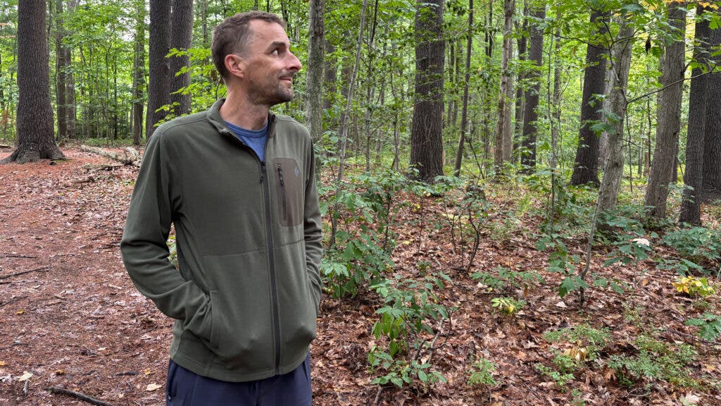 Outside tester wearing green Black Diamond Rift Full-Zip Fleece Jacket in woods during fall