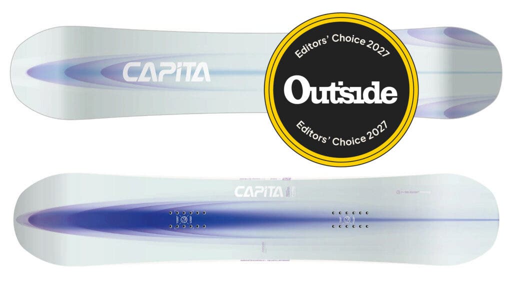 Blue-and-white top sheet and base of the CAPiTA Artemis Women's snowboard with an Outside Editors' Choice 2027 badge, our pick for the best snowboard for women