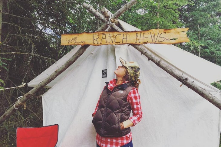  Author Madison Dapcevich stands outside of her wall tent in Cooper Landing, Alaska