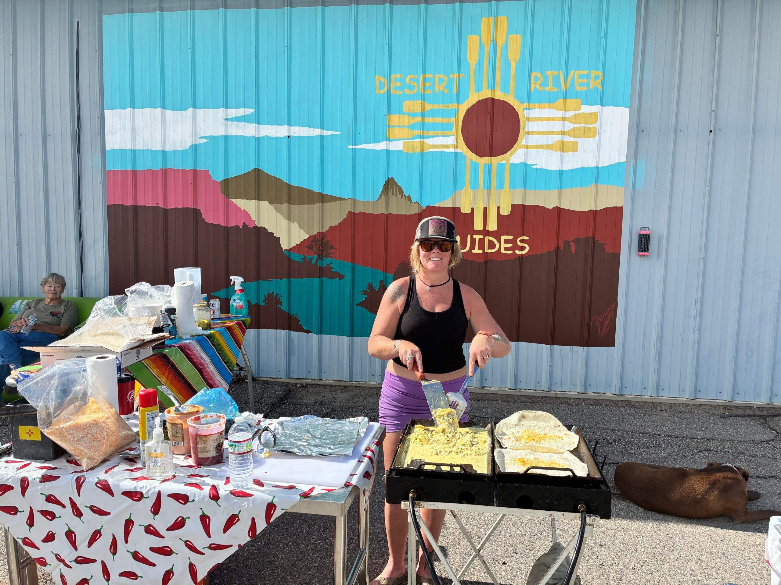 Ryan Dudgeon making breakfast for volunteer rescuers and animal caretakers outside of the Desert River Guides warehouse