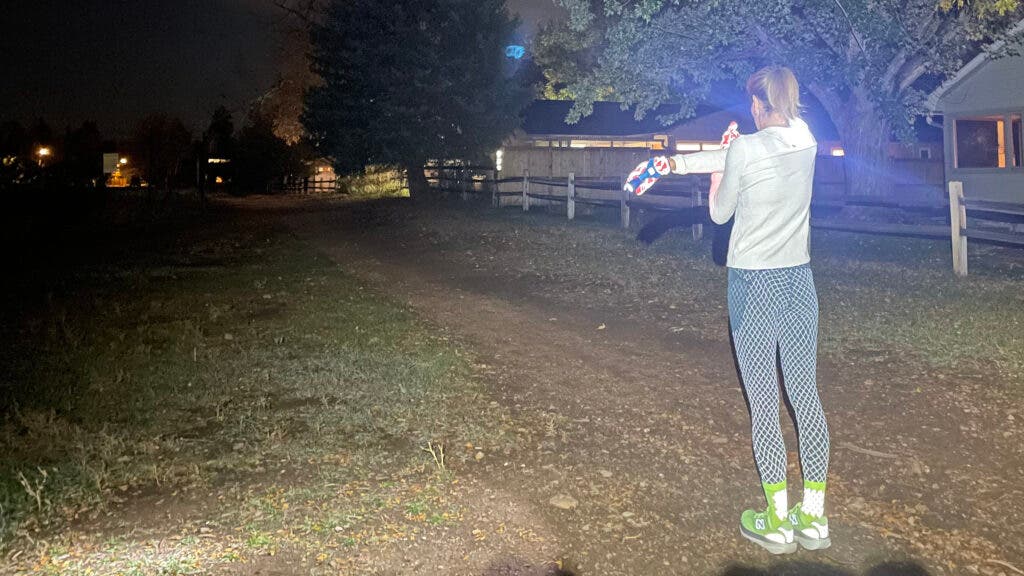 Runner wearing Janji 5” Pace Shorts on a night run