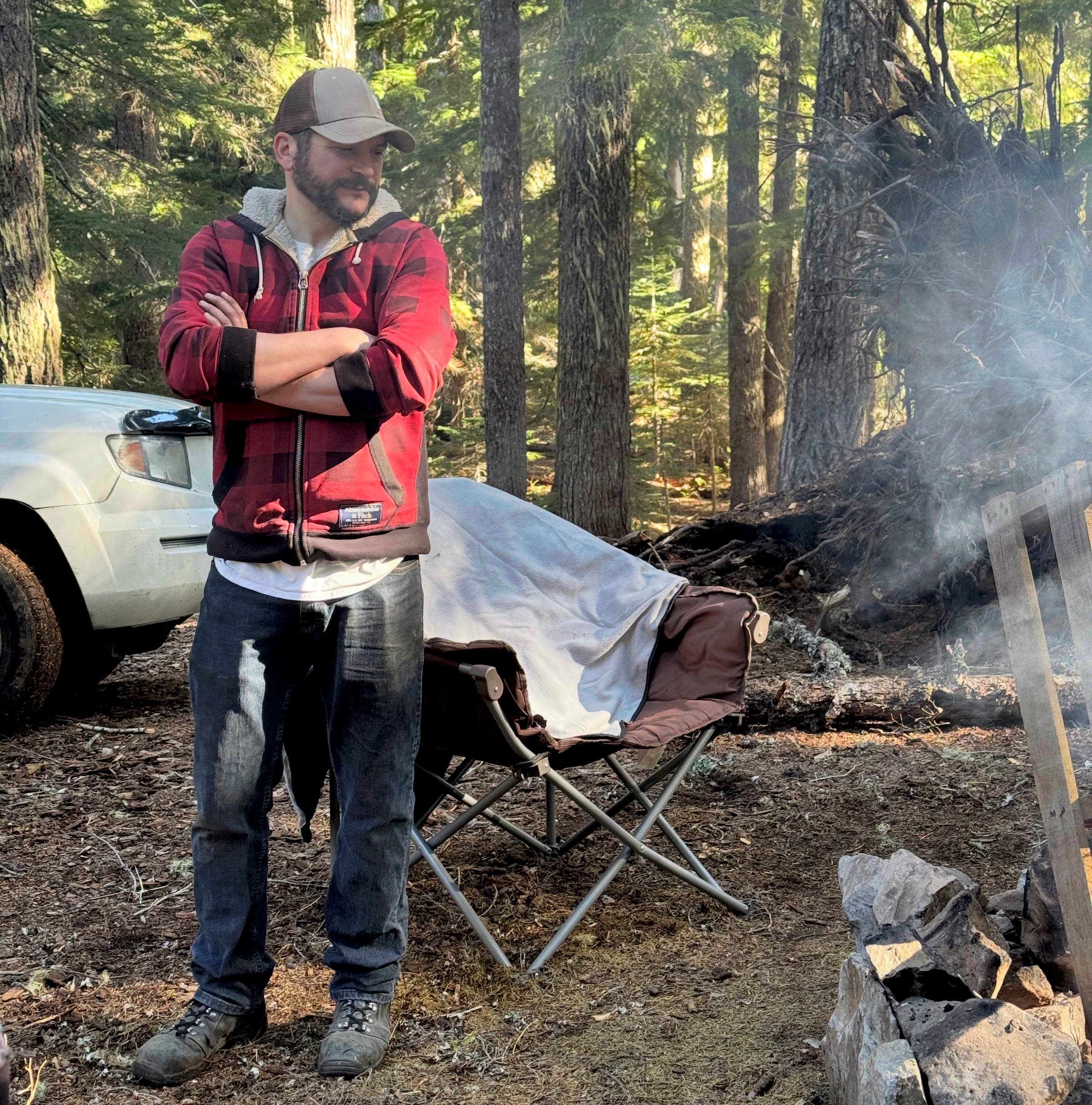 man in red flannel watches fire