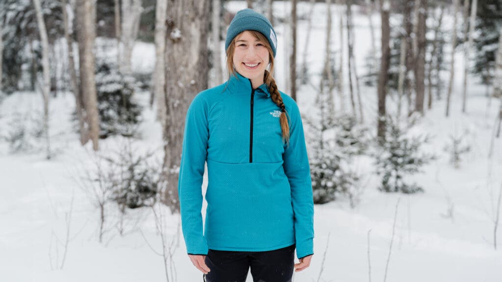 Woman wearing The North Face Women’s Summit Series Futurefleece LT ½-Zip in snowy woods